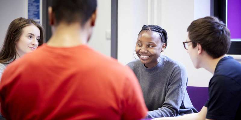 Students relaxing in group area of Social Sciences building