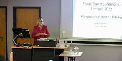 Zoe Billingham delivers the 2022 Frank Dawtry Memorial Lecture.
Zoe stood in front of a projector screen.