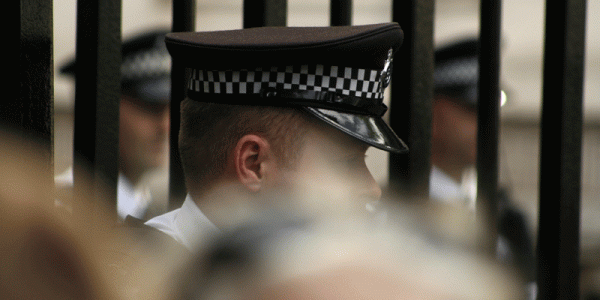 Police officer viewed through a crowd
