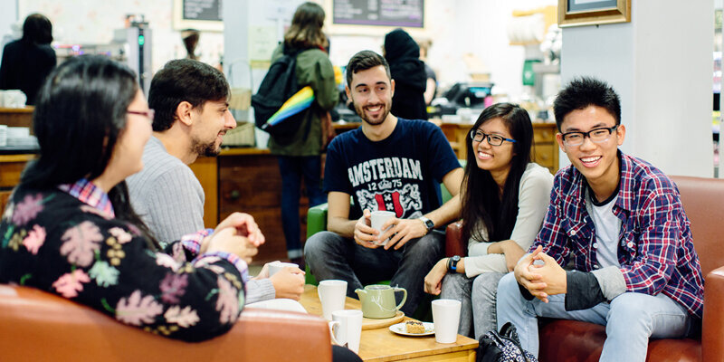 International students catching up over coffee at the Global Cafe